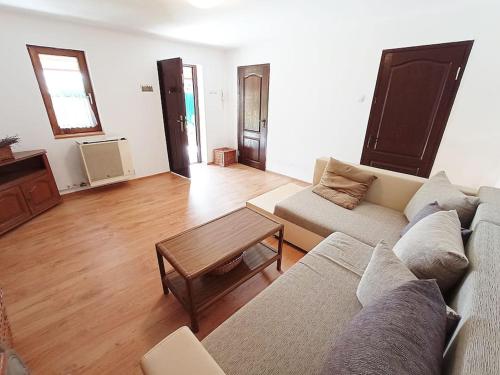a living room with a couch and a table at Private House with Garden in Mislea