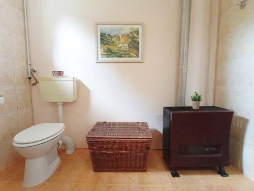 a bathroom with a toilet and a wooden floor at Private House with Garden in Mislea