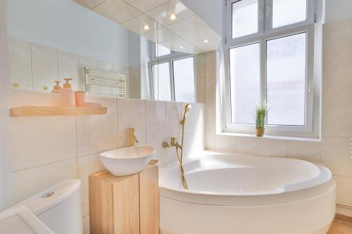 a bathroom with a tub and a toilet and a sink at Sopot City Centre, Apartment 774 in Sopot