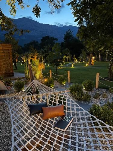 a hammock in a park with a book on it at Butiq Garden in Kemer