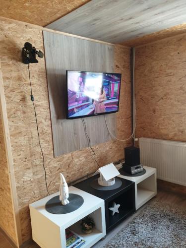 a living room with a flat screen tv on a wall at Chata pod zubačkou in Tatranska Strba