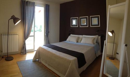 a bedroom with a large bed and a large window at B&B Day by day in Iseo