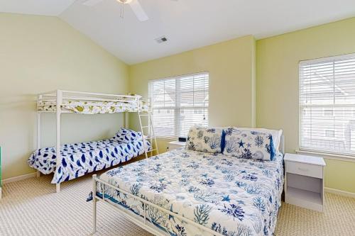 a bedroom with a bed and a bunk bed at Rehoboth Crossing --- 19913 Ames Drive #106 in Rehoboth Beach