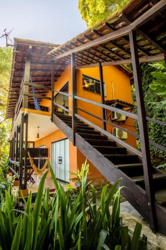a house with a staircase leading up to it at Pousada Lagamar in Praia Vermelha
