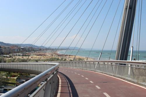 a bridge over a road with a view of the ocean at Novatek Apartment 201 Exclusive in Pescara