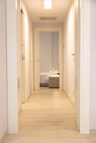 a hallway leading to a bedroom with a bed at Novatek Apartment 201 Exclusive in Pescara