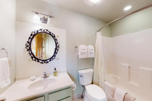a bathroom with a sink and a toilet and a mirror at San Juan Siesta in South Fork