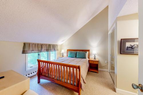 a bedroom with a bed and a window at Hemlock Nob B11 in Sugar Mountain