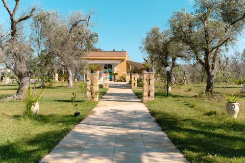 a sidewalk in front of a house with trees at Tenuta San Lorenzo in Otranto
