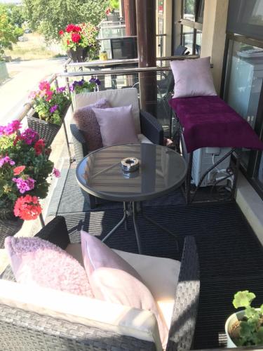 a balcony with pillows and a table and chairs at Studio Oscar in Saturn