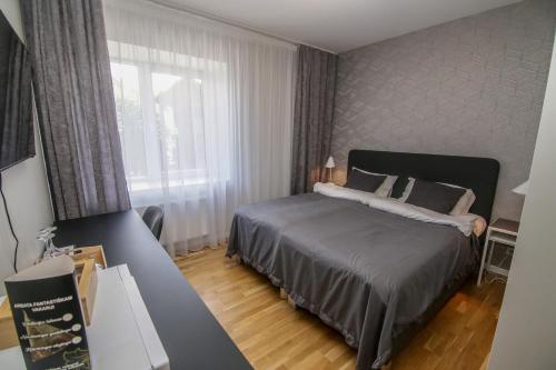 เตียงในห้องที่ Akmenės svečių apartamentai Šypsena