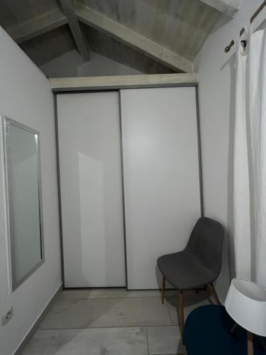 a room with four sliding glass doors and a chair at Romantic apartments in Šibenik