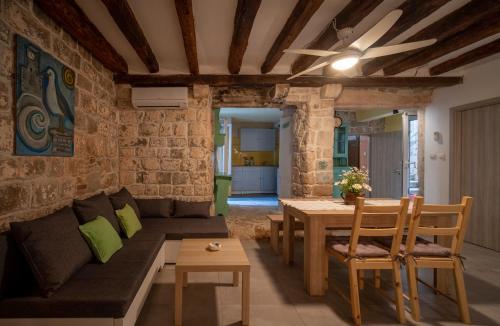 a living room with a couch and a table at Manor house Aman in Komiža