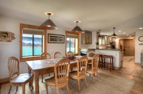 a kitchen and dining room with a wooden table and chairs at Blessings in Creede