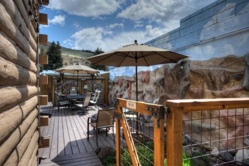 a patio with an umbrella and chairs on a deck at Blessings in Creede