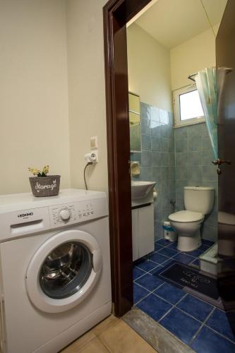 a bathroom with a washing machine and a toilet at Irinis studio in Rhodes Town