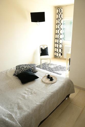 a bedroom with a bed with black and white pillows at Locanda Divinis in Cerea