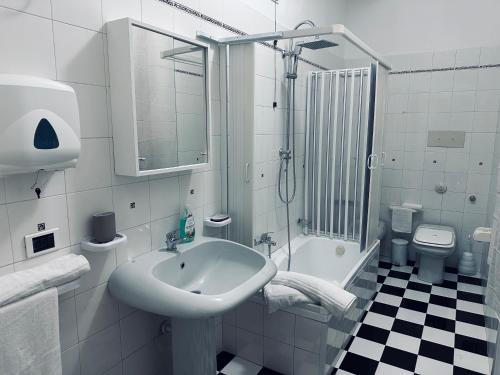 a bathroom with a sink and a shower and a toilet at Siliade Apartment in Montesilvano