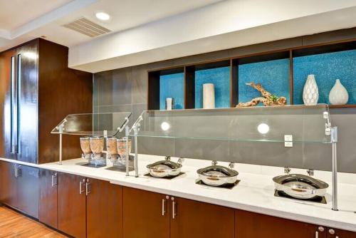 a kitchen with a counter with bowls and vases at SpringHill Suites by Marriott Orlando Lake Buena Vista South in Kissimmee