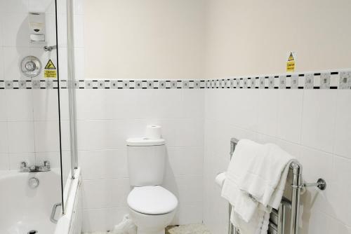 a white bathroom with a toilet and a shower at The Northwick Arms Hotel in Evesham