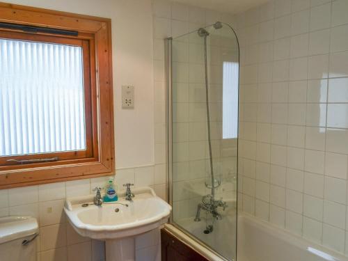 a bathroom with a sink and a shower at Larch Lodge - Uk37187 in Legbourne