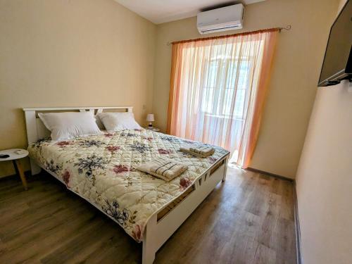 a bedroom with a bed and a large window at Nadalina Guest House in Kotor