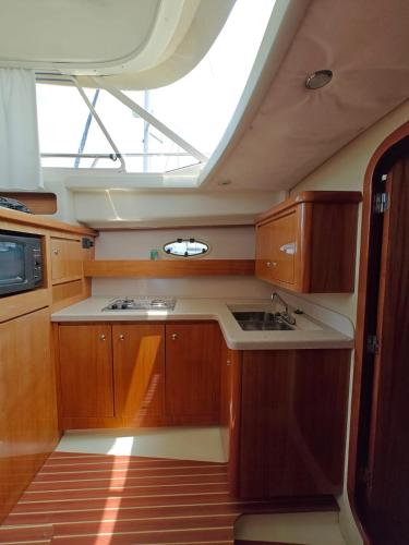 a kitchen with wooden cabinets and a skylight at Seacascais, Lda in Cascais