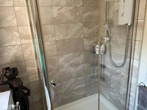 a bathroom with a shower with a glass door at Central Aster House, 3 Bedrooms, Parking in Nottingham