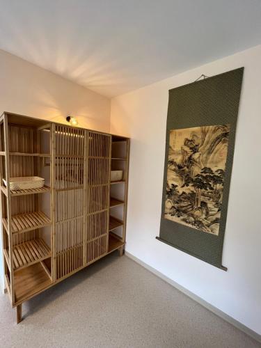 a room with wooden shelves and a painting on the wall at Ferienwohnung Schmidt in Wernigerode