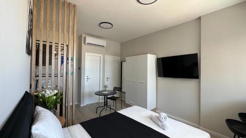 a bedroom with a bed and a tv in it at Angel Apt-Amazing SeaView-Netfix-Wifi-Free Parking in Ashdod