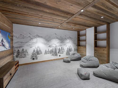 a room with three beds and a mural of mountains at Appartement Les Allues-Méribel, 5 pièces, 10 personnes - FR-1-566-2 in Les Allues
