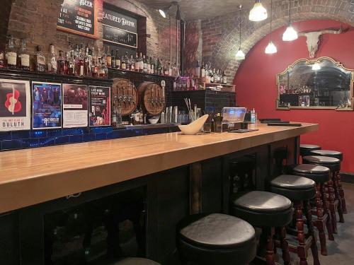 a bar with stools in a room at The Oliver Inn in Duluth