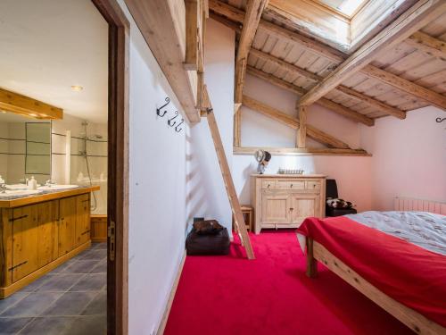 a bedroom with a red carpet and a bed and a bathroom at Chalet Méribel, 6 pièces, 10 personnes - FR-1-566-23 in Les Allues