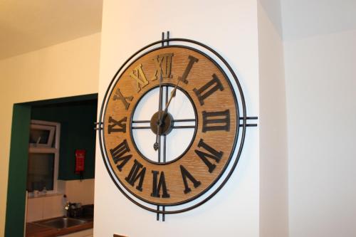 a clock on the side of a wall at Cosy Home Ideal for Business, Contractors, Families near Walsgrave Hospital, Shops and M6, A46, Free Parking in Wyken