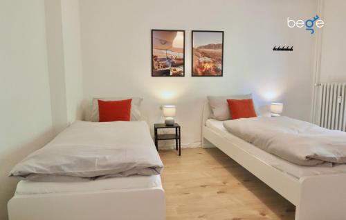 a room with two beds and a couch in it at BEGE APARTMENTS: PERFECT FOR COMPANIES in Gelsenkirchen