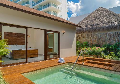a villa with a swimming pool and a bedroom at The Westin Cozumel in Cozumel