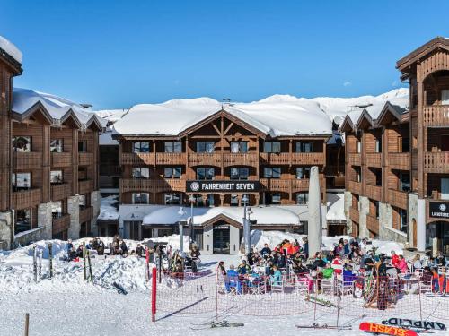 a group of people standing in front of a ski lodge at Appartement Courchevel 1650, 2 pièces, 4 personnes - FR-1-563-82 in Courchevel