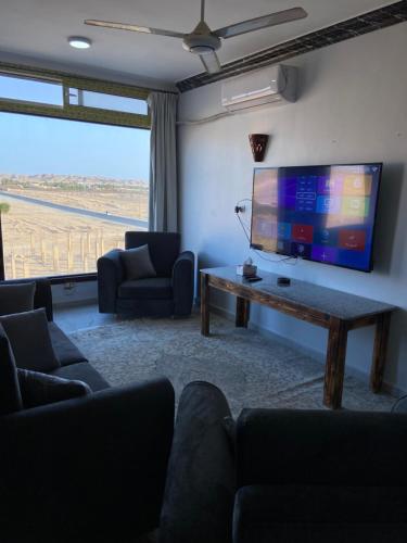 a living room with a tv and a couch and a table at German Dolphin in Quseir