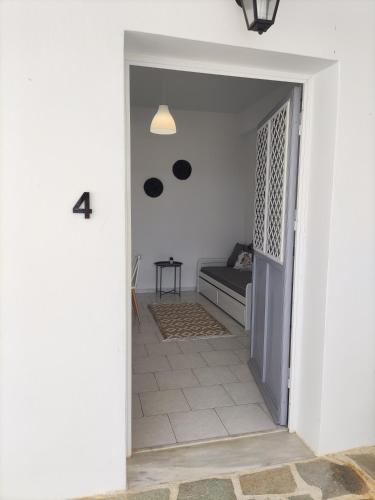 a hallway leading to a living room with a couch at Galini Rooms & Apartments in Finikas