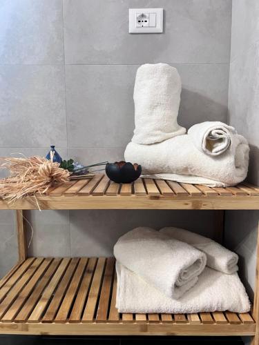 una mensola in legno con asciugamani in bagno di La Piazzetta a L'Aquila