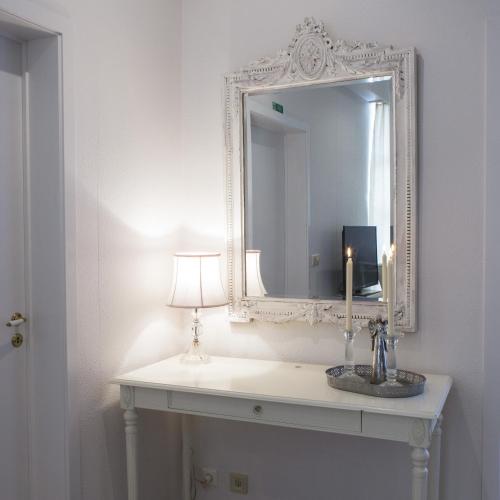 a bathroom with a mirror and a candle on a sink at River Apartments in Selfoss