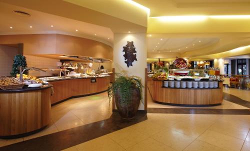 a restaurant with a buffet line with food on display at Suite Hotel Eden Mar - PortoBay in Funchal