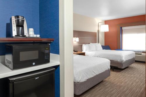 a hotel room with two beds and a tv at Holiday Inn Express Hotel & Suites Coeur D'Alene I-90 Exit 11, an IHG Hotel in Coeur d'Alene