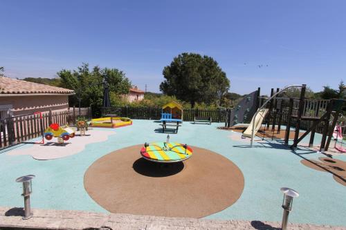 a playground with a bunch of inflatableogieapons at "AU HAVRE DE PAIX" 5 étoiles Prestige jacuzzi, hammam, sauna, PISCINE chauffée Mougins Cannes Grasse in Mougins