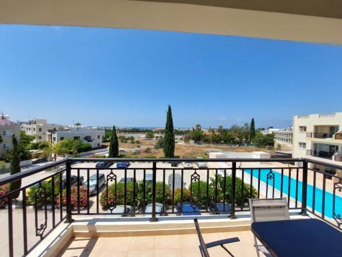 a balcony with a view of the swimming pool at Stunning views' Apartment with Pool in Paphos
