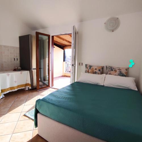 a bedroom with a large green bed in a room at Vista Mare Olbia in Olbia