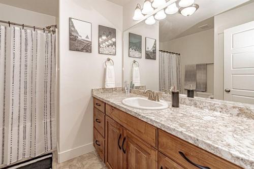 a bathroom with a sink and a mirror at Stunning 5 Bedroom Rexburg Home in Rexburg