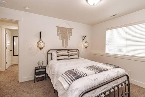 a bedroom with a large bed and a window at Stunning 5 Bedroom Rexburg Home in Rexburg