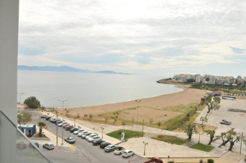 a view of a beach with cars parked next to the water at Hotel Avra by Smile hotels - Free Airport Shuttle in Rafina