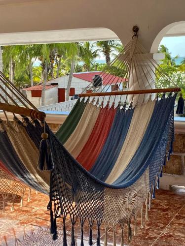 a couple of hammocks in a room at Casa Gajah Hotel Cuyo in El Cuyo